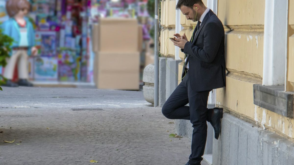 A man using his phone on the street