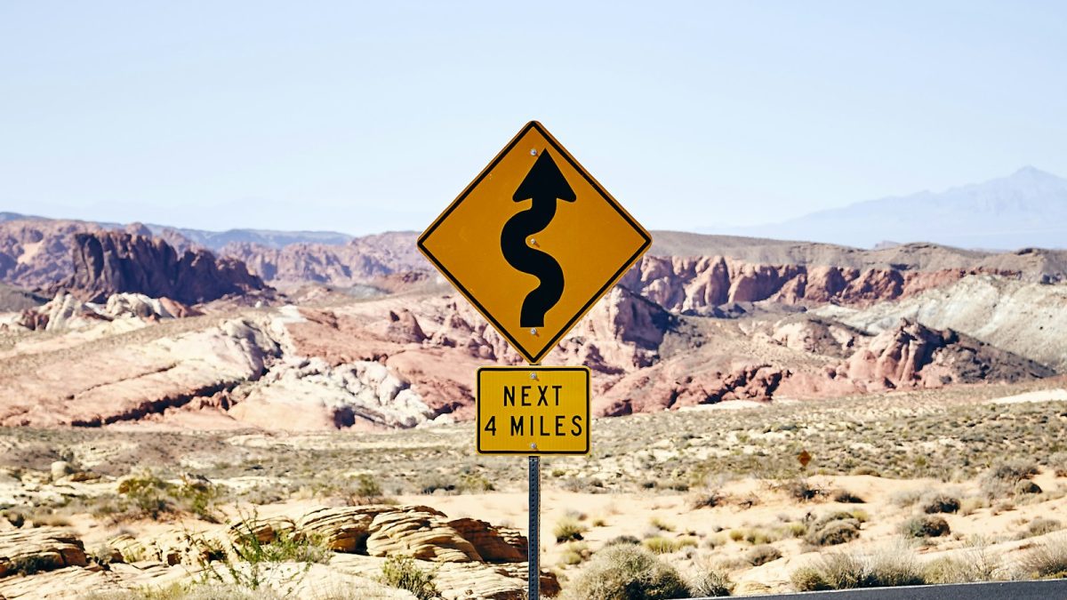 A road sign warning of a bend